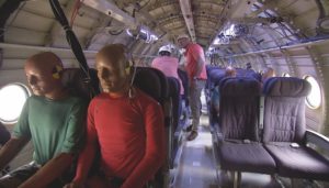 Researchers prepare crash test dummies inside the Fokker F-28