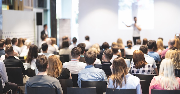 Blurred image of a crowd at a conference