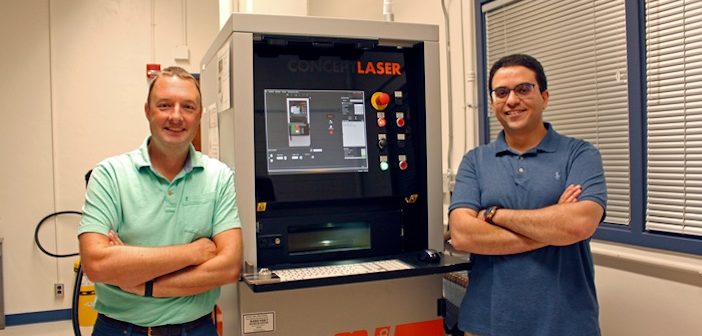 researchers in front of a machine