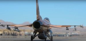 A 64th AGRS F-16 taxiing out for a sortie with an Angry Kitten pod on the left inboard wing pylon. The footage was taken during the Red Flag 19-2 exercise in June, 2019 indicating that USAF aggressor aircraft may have already been carrying the pods for several years (Credit: US Air Force /Youtube)